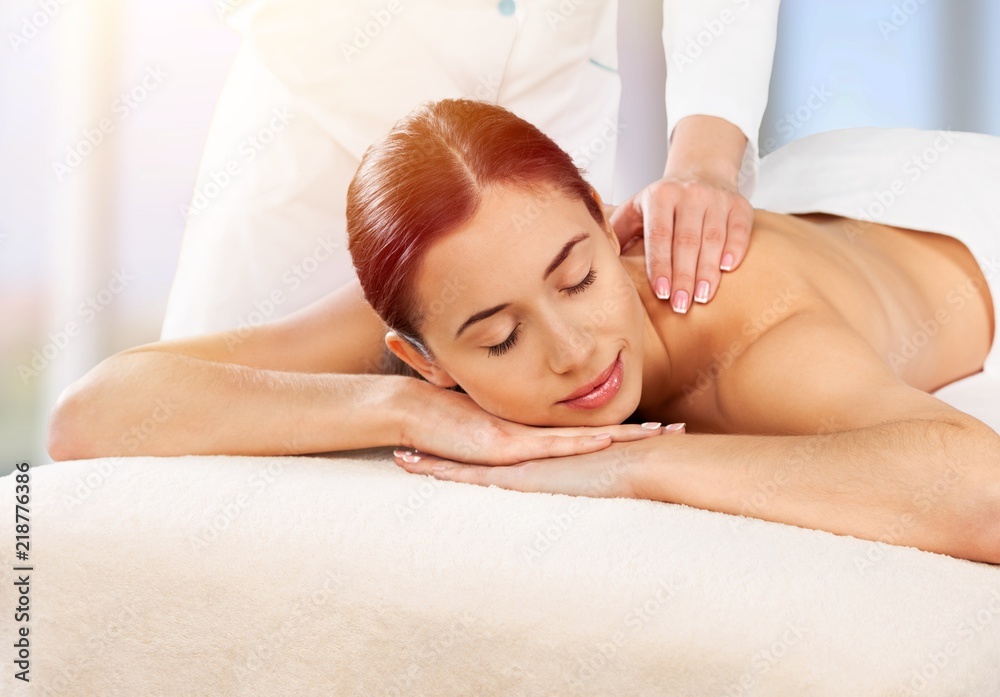 Beautiful young woman enjoying head massage in spa center Beautiful young woman enjoying head massage in spa center