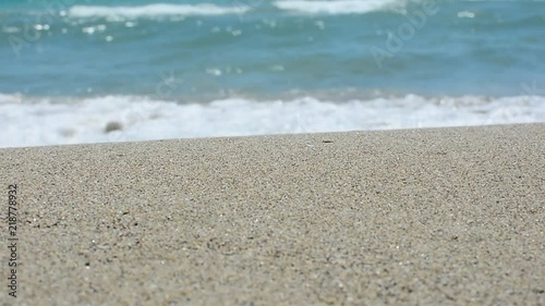 Sea waves over sand beach, holiday background