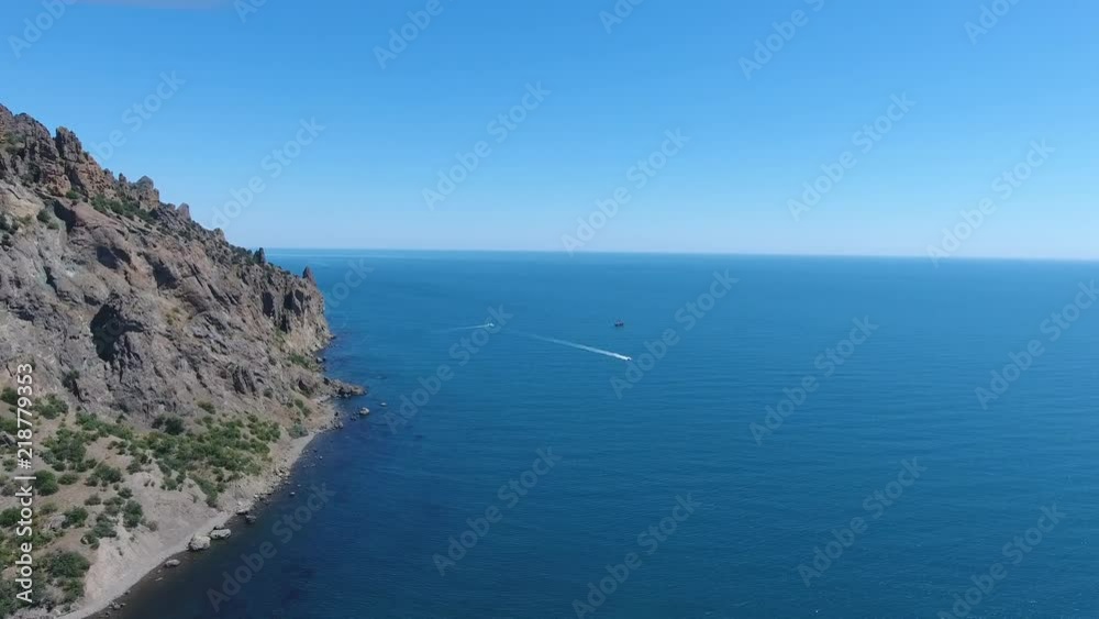 Top view: Many ships in opened Black sea sailing in Crimea near mountains. Boat to ocean Aerial view yacht from drone Yachting video Sailboat from drone Sailing video Yachting at windy day sailboat. Top view: Many ships in opened Black sea sailing in Crimea near mountains. Boat to ocean Aerial view yacht from drone Yachting video Sailboat from drone Sailing video Yachting at windy day sailboat.