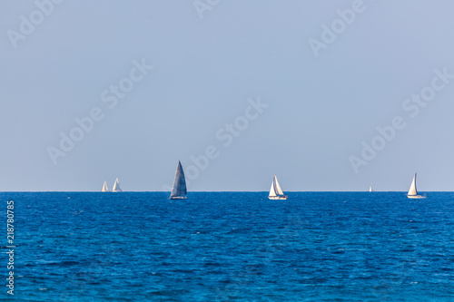 Six yachts with white and gray sails on Mediterranean Sea