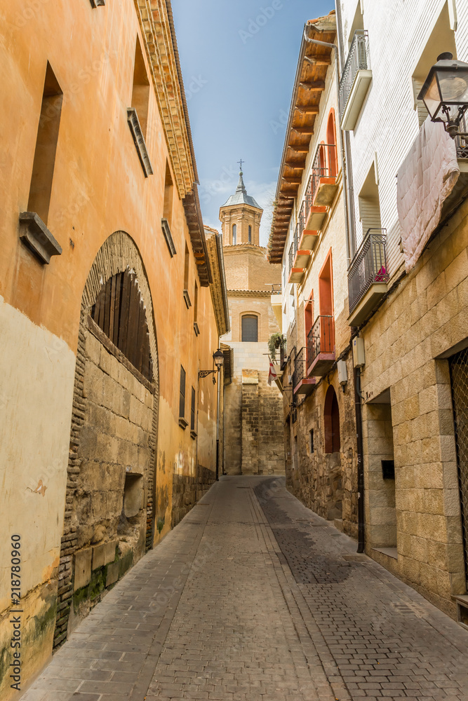 Street leading to a church tower in Tudela, Spain