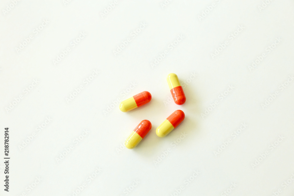 Yellow-red capsules. Some capsules and pills isolated on white background Yellow-red capsules. Some capsules and pills isolated on white background