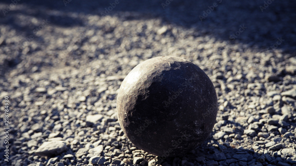 Old petanque balls on the ground. Steel ball on the ground. Light and shadow. Old petanque balls on the ground. Steel ball on the ground. Light and shadow.