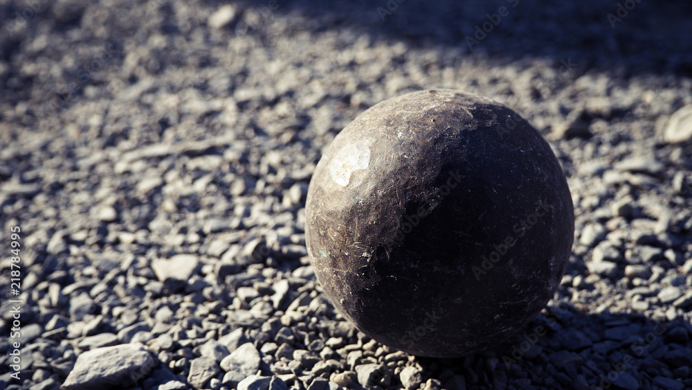 Old petanque balls on the ground. Steel ball on the ground. Light and shadow. Old petanque balls on the ground. Steel ball on the ground. Light and shadow.