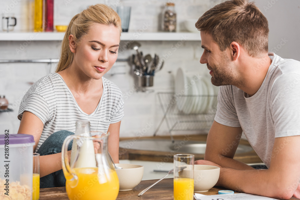 young couple having breakfast in kitchen young couple having breakfast in kitchen