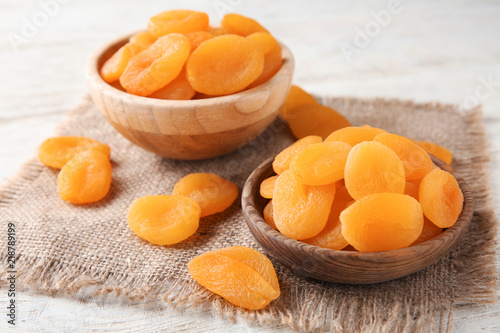 Foto Bowls with dried apricots on table