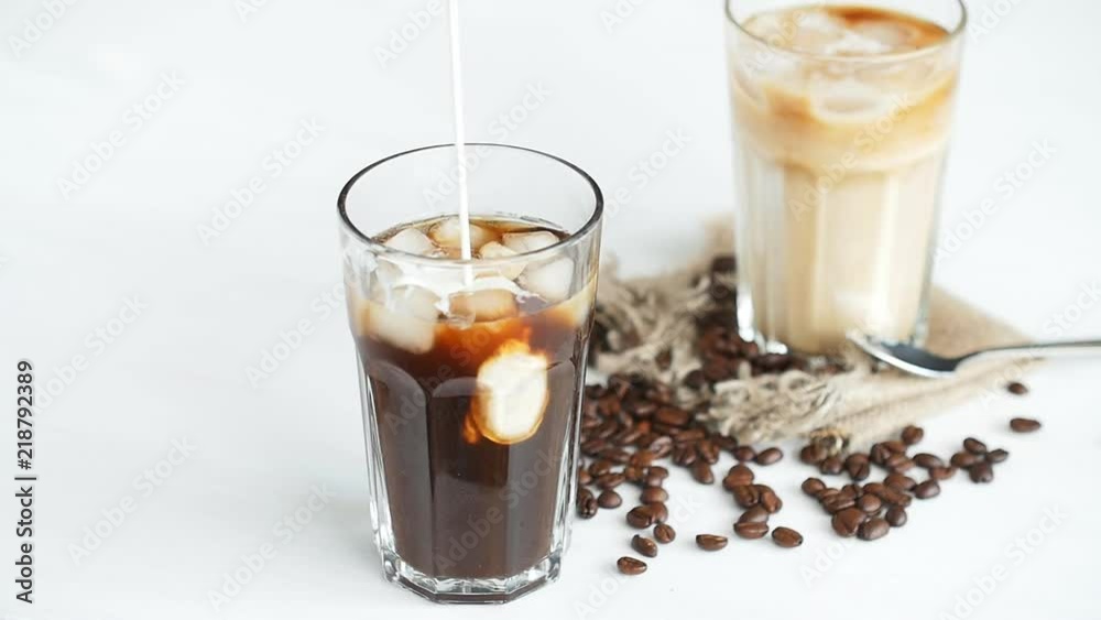 Cream poured into a iced coffee cocktail Cream poured into a iced coffee cocktail