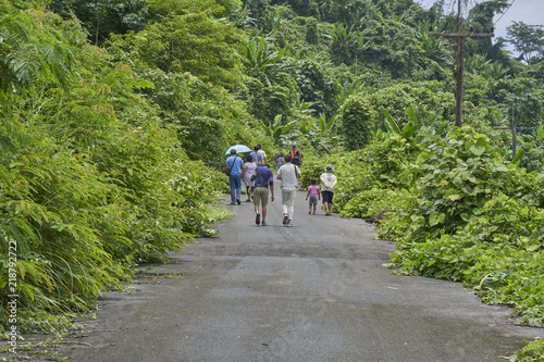 People walk up hillside 