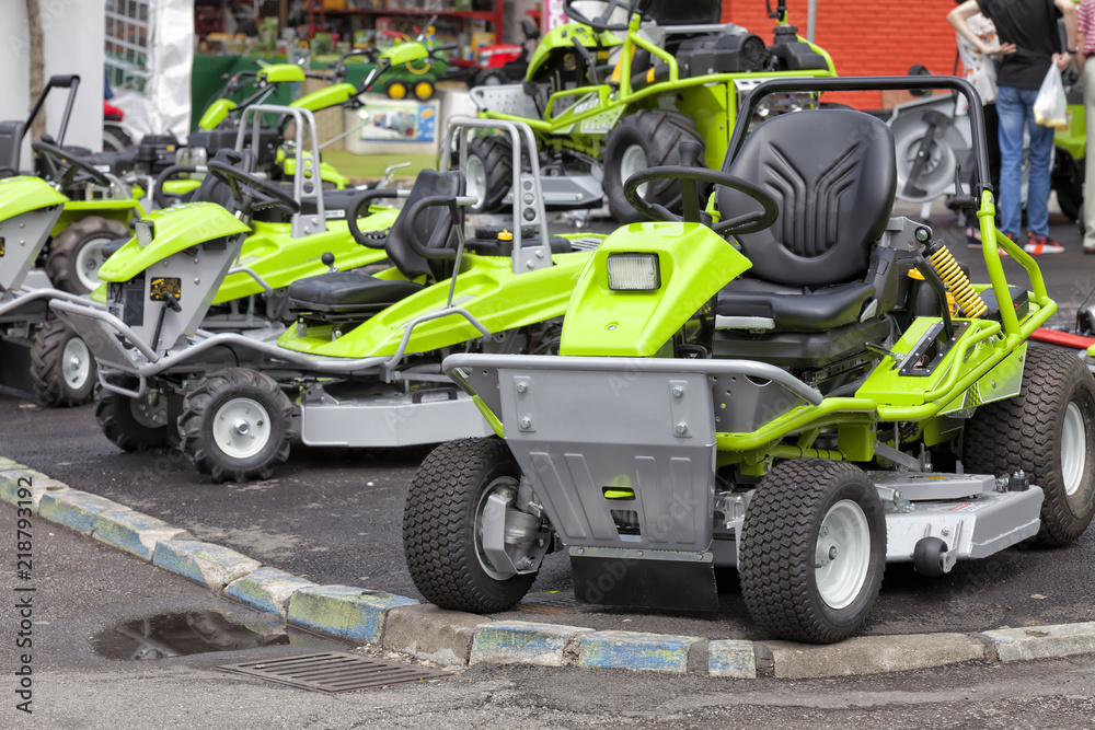 Several lawnmowers exhibited at an agricultural machinery fair Several lawnmowers exhibited at an agricultural machinery fair