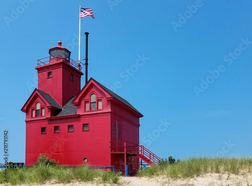 red lighthouse in Holland Michigan harbor with blue sky background