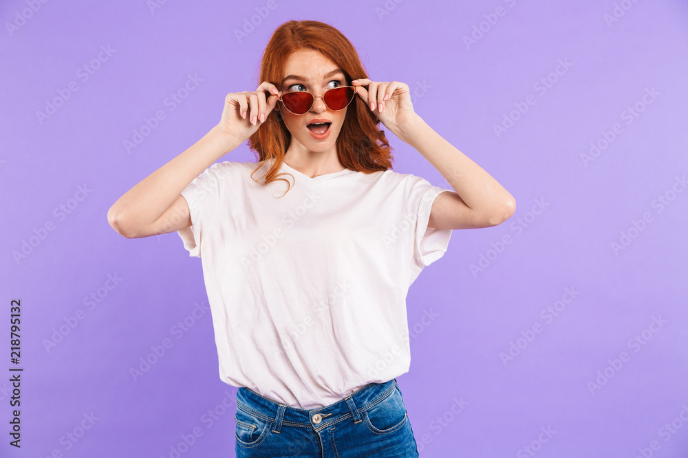 Portrait of a surprised young girl in sunglasses