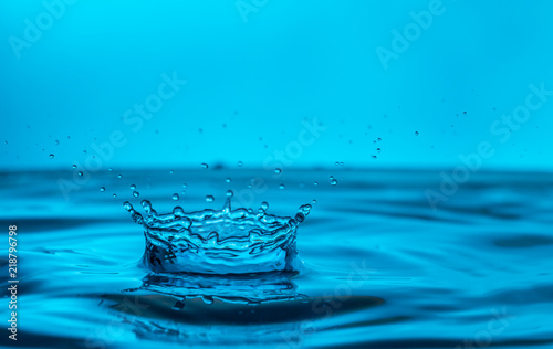 single water drop splashing in a body of water