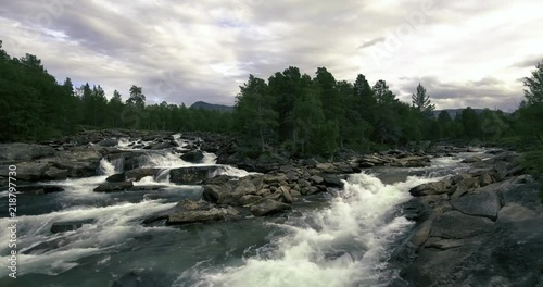 Incredible aerial view of the river that flows in magic landscape in Norway with mountains in background