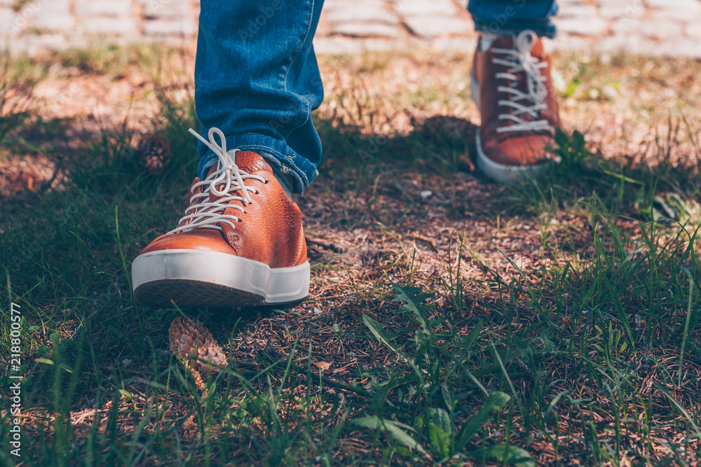A walk in the woods, close-up of shoes comes on a bump A walk in the woods, close-up of shoes comes on a bump
