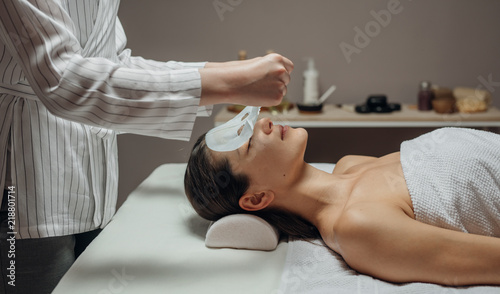 Cosmeotologist Putting a Facial Mask