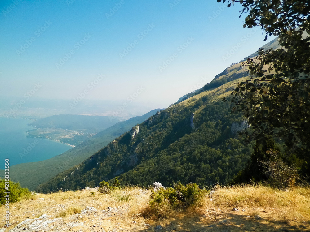 Obraz premium Water of Lake Ohrid and Mountains of Galicica National Park, Macedonia.