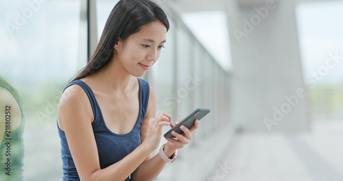 Woman sending sms on mobile phone in Shenzhen city