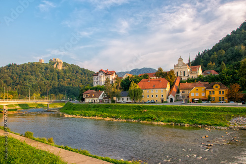 Scenic view on river Savinja, Capuchin monastery, houses in Breg and castle hill in Celje, Slovenia photo