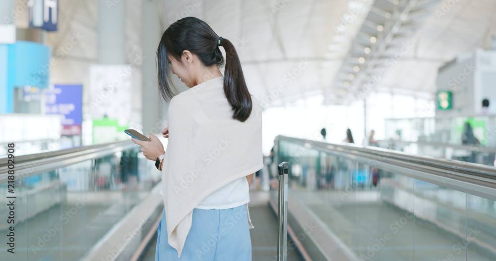 Woman use of mobile phone in the airport