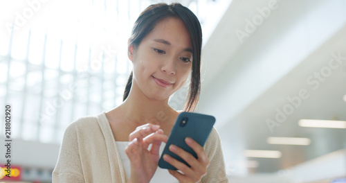 Photography Woman use of cellphone inside airport