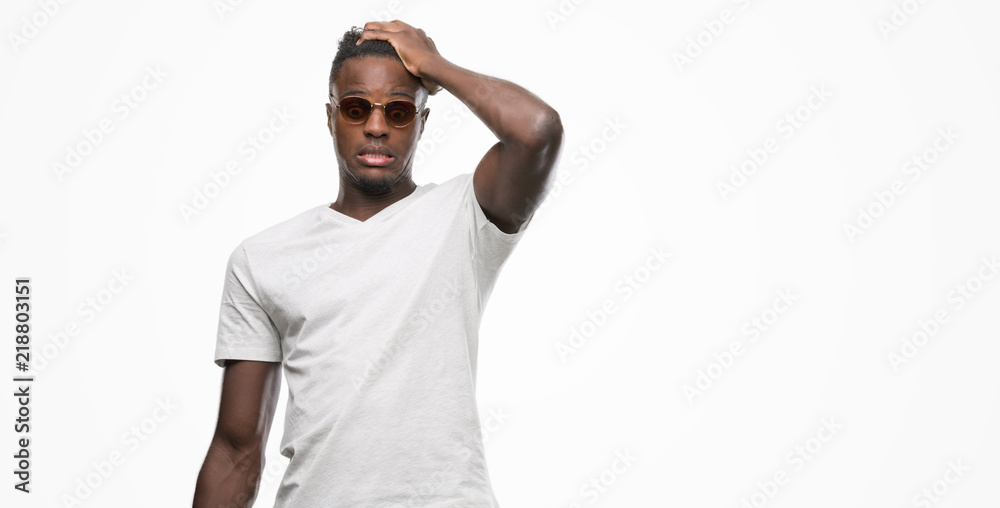 Young african american man wearing sunglasses stressed with hand on head, shocked with shame and surprise face, angry and frustrated. Fear and upset for mistake. Young african american man wearing sunglasses stressed with hand on head, shocked with shame and surprise face, angry and frustrated. Fear and upset for mistake.