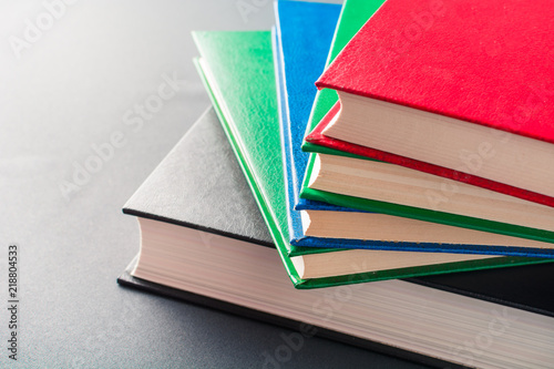 Beautiful colorful books lie on a gray background