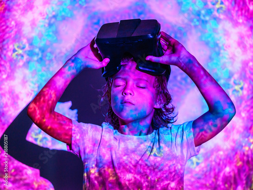 Focused boy with VR glasses under projection photo