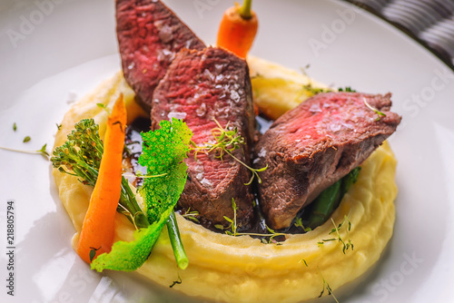 Canvas Print delicious venison steak with potatoes mash and vegetables on white plate, produc