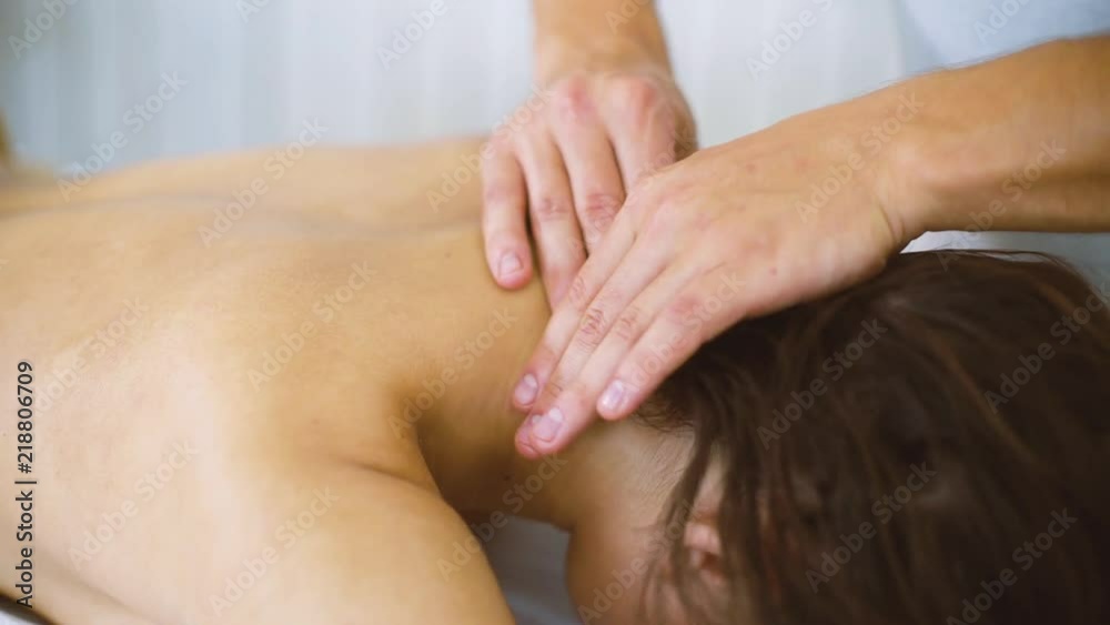 Male masseur massaging beautiful woman hand in spa closeup. Young female enjoying professional spine treatment. Rehabilitation, medicine, manual therapy, beauty, wellness, healthy concept Male masseur massaging beautiful woman hand in spa closeup. Young female enjoying professional spine treatment. Rehabilitation, medicine, manual therapy, beauty, wellness, healthy concept