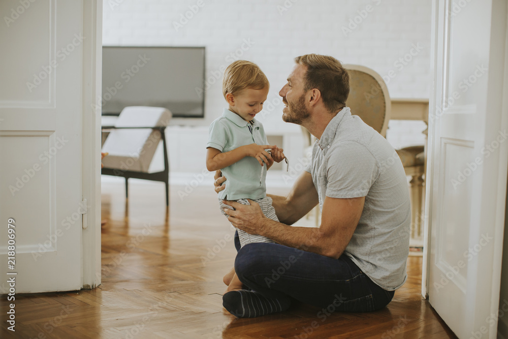 Happy father and little son playing and having fun at home Happy father and little son playing and having fun at home