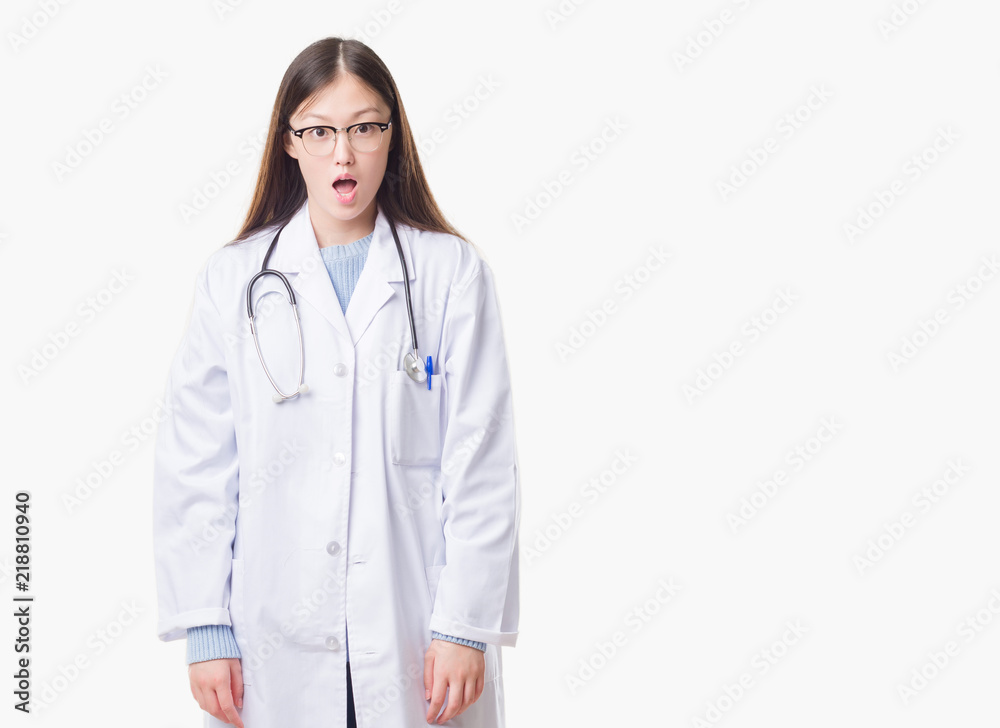 Young Chinese doctor woman over isolated background afraid and shocked with surprise expression, fear and excited face. Young Chinese doctor woman over isolated background afraid and shocked with surprise expression, fear and excited face.