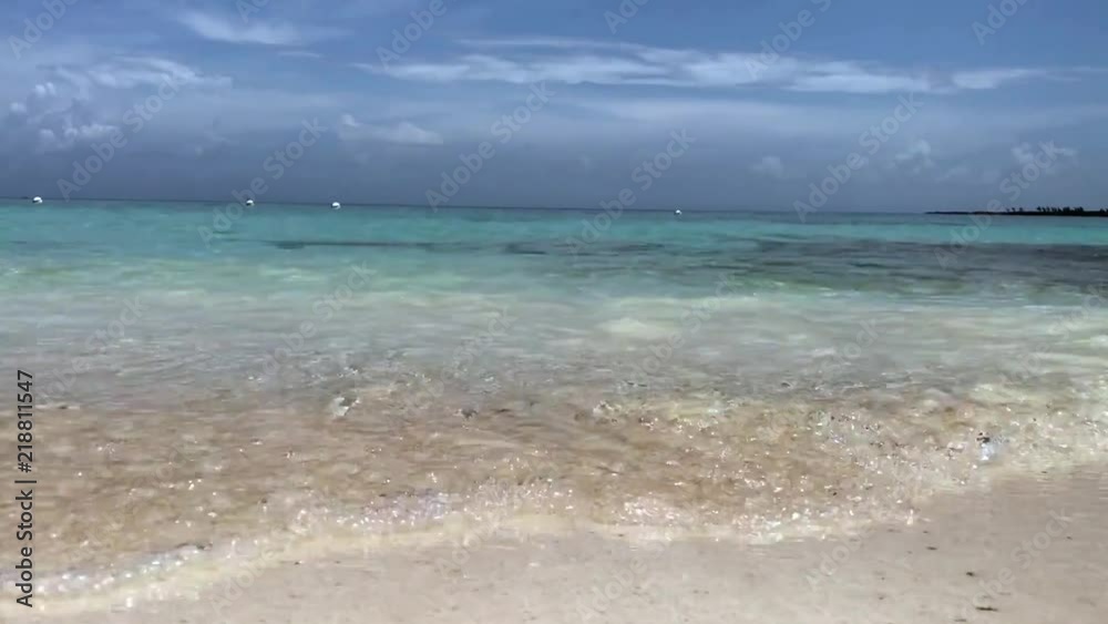 Waves on a private beach in the Bahamas. Blue party cloudy skies. Waves on a private beach in the Bahamas. Blue party cloudy skies.