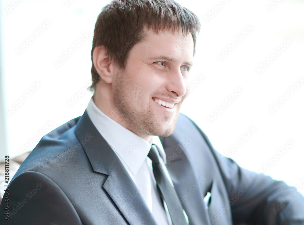 close up. smiling businessman reading a business document close up. smiling businessman reading a business document