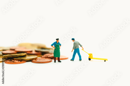 Miniature people, chief control worker lifting stack coins using as business and financial concept