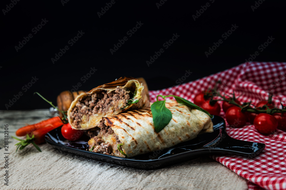 Mexican fajita wraps with grilled chicken fillet and fresh vegetables Mexican fajita wraps with grilled chicken fillet and fresh vegetables