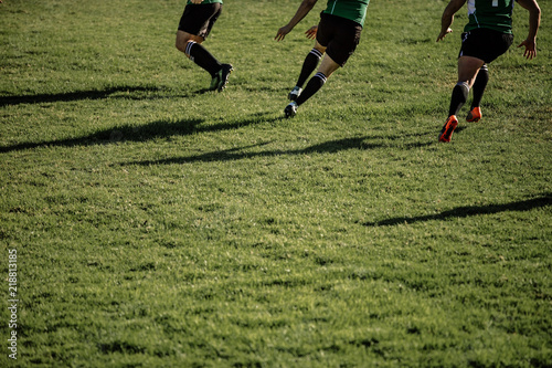 Rugby team playing match at grassy field