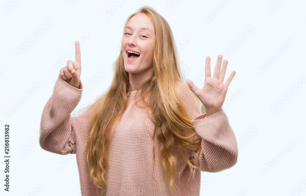 Blonde teenager woman wearing pink sweater showing and pointing up with fingers number six while smiling confident and happy. Blonde teenager woman wearing pink sweater showing and pointing up with fingers number six while smiling confident and happy.