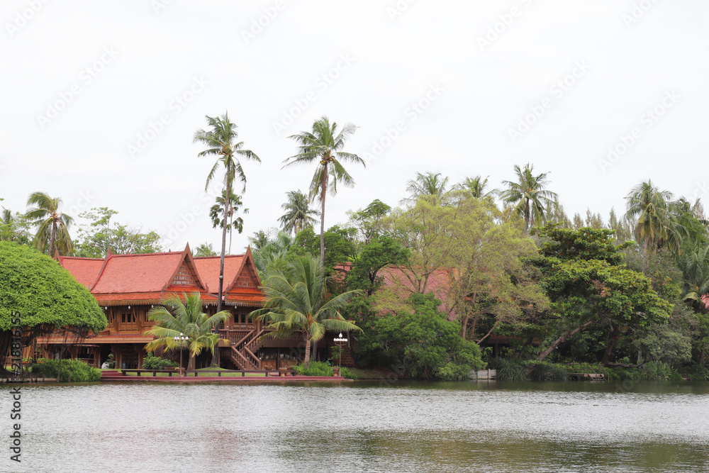 Scenery of beautiful Thai style houses in the garden nearby the lake. Scenery of beautiful Thai style houses in the garden nearby the lake.