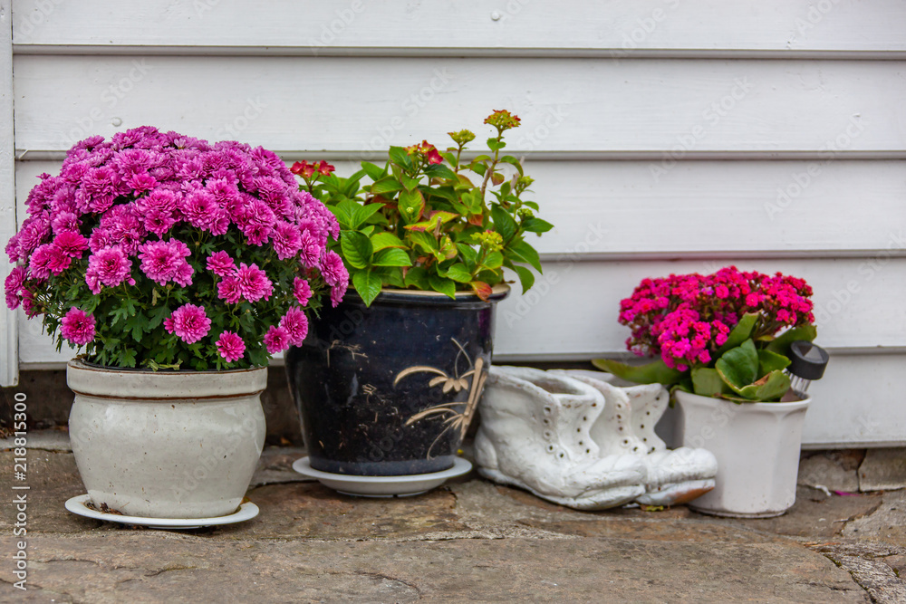 Pots with flowers and vintage things decorate beautiful cobbled street in the southern Norwegian town Mandal