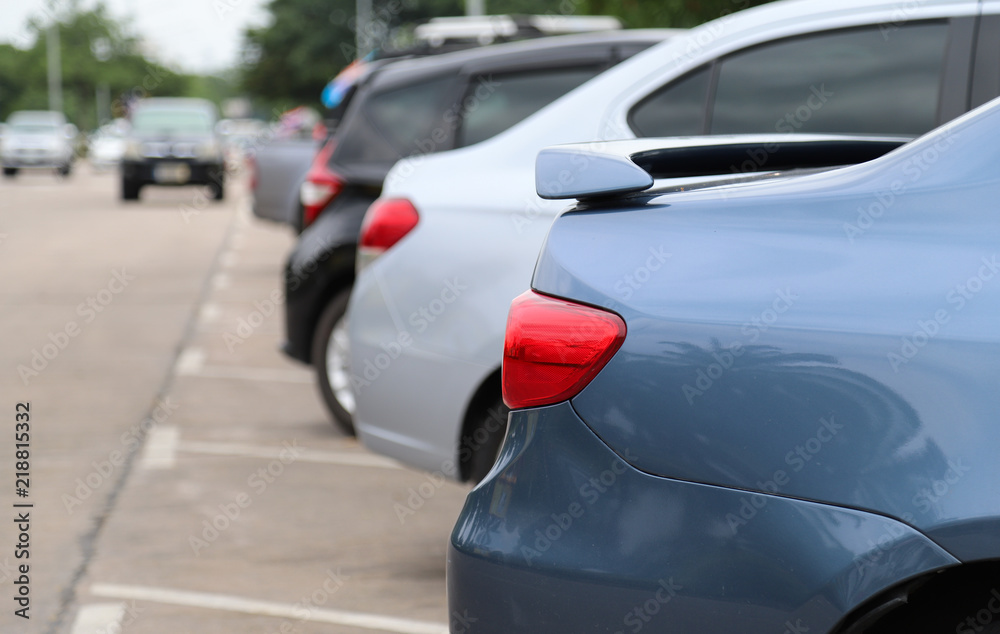 Closeup of rear side of blue car park in parking area in sunny day. 