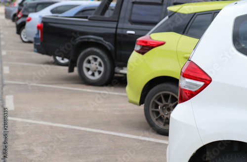 Closeup of rear side of white car park in parking area in sunny day. 