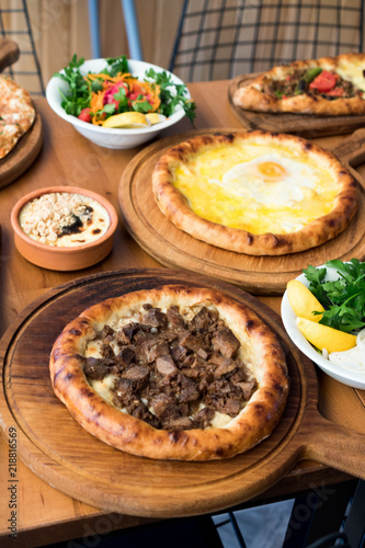 Variety of Turkish Pide Traditional food with beef, Cheese, Fried Egg and Salad.
