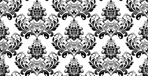Wallpaper in the style of Baroque. Seamless vector background. White and black floral ornament. Graphic pattern for fabric, wallpaper, packaging. Ornate Damask flower ornament