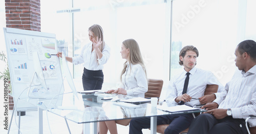 woman presenting her idea to colleagues at meeting