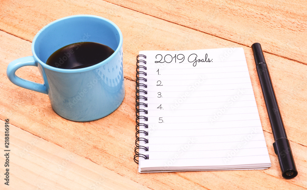 Coffee and notebook with goals for 2019 Coffee and notebook with goals for 2019