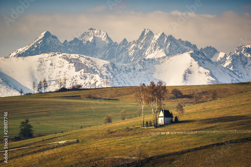 Fototapeta Naklejka Na Ścianę i Meble -  Landscape with a chapel and snow-covered Tatra Mountains in Kacwin, Malopolskie, Poland