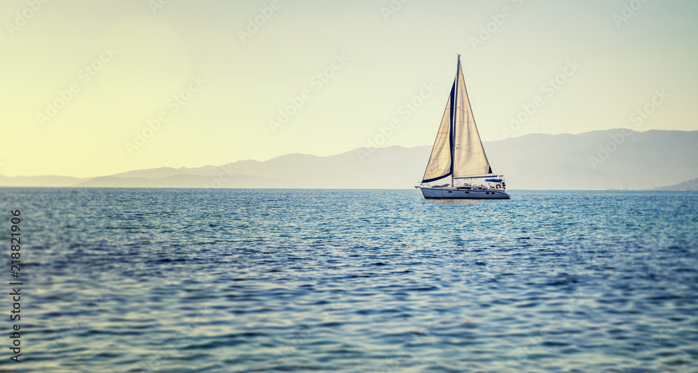Sailing yacht in Mediterranean sea at sunset. Travel and active lifestyle concept