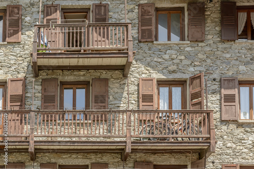 bikes parked on wooden balcony of traditonal stone house, Gressoney Saint Jean, Italy