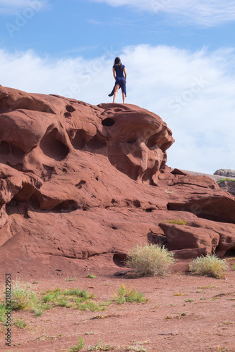 young woman in a blue dress on top of a mountain