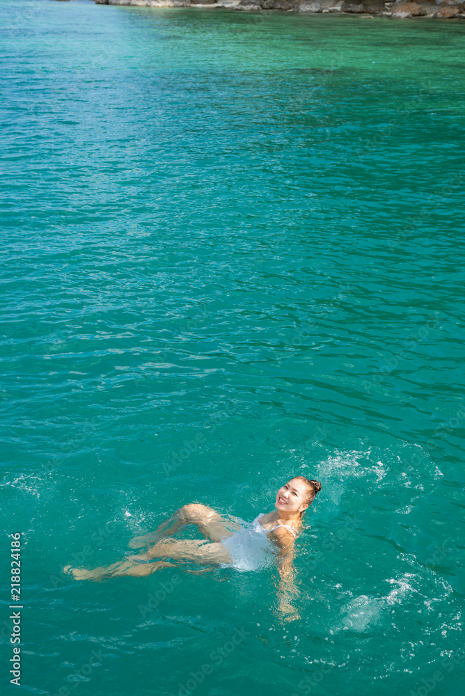 Sea series: Asian woman swimming in the sea